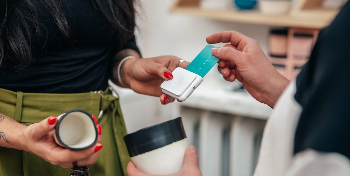 merchant-taking-sale-with-chip-and-swipe-reader-shopify-plus