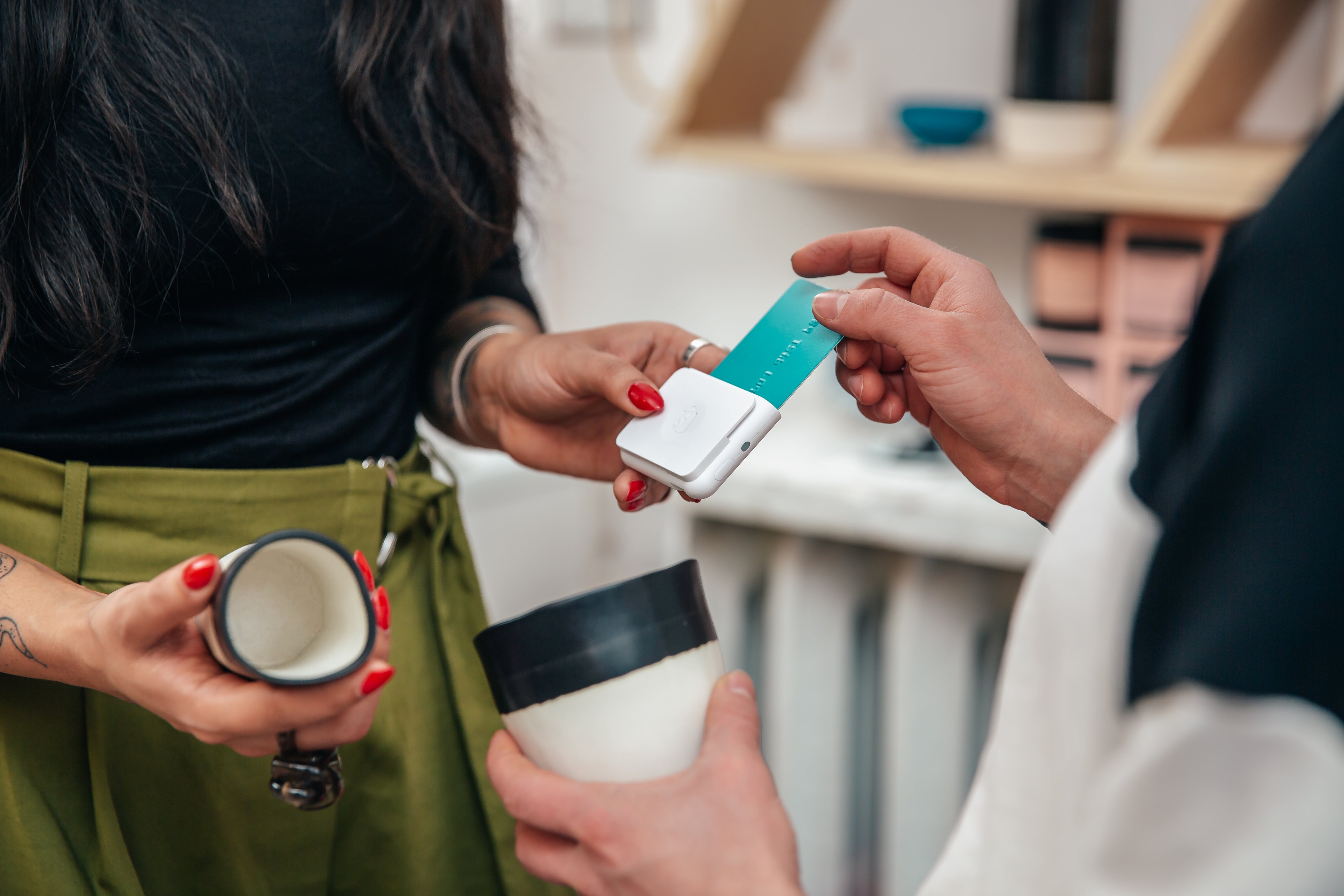 merchant-taking-sale-with-chip-and-swipe-reader-shopify-plus