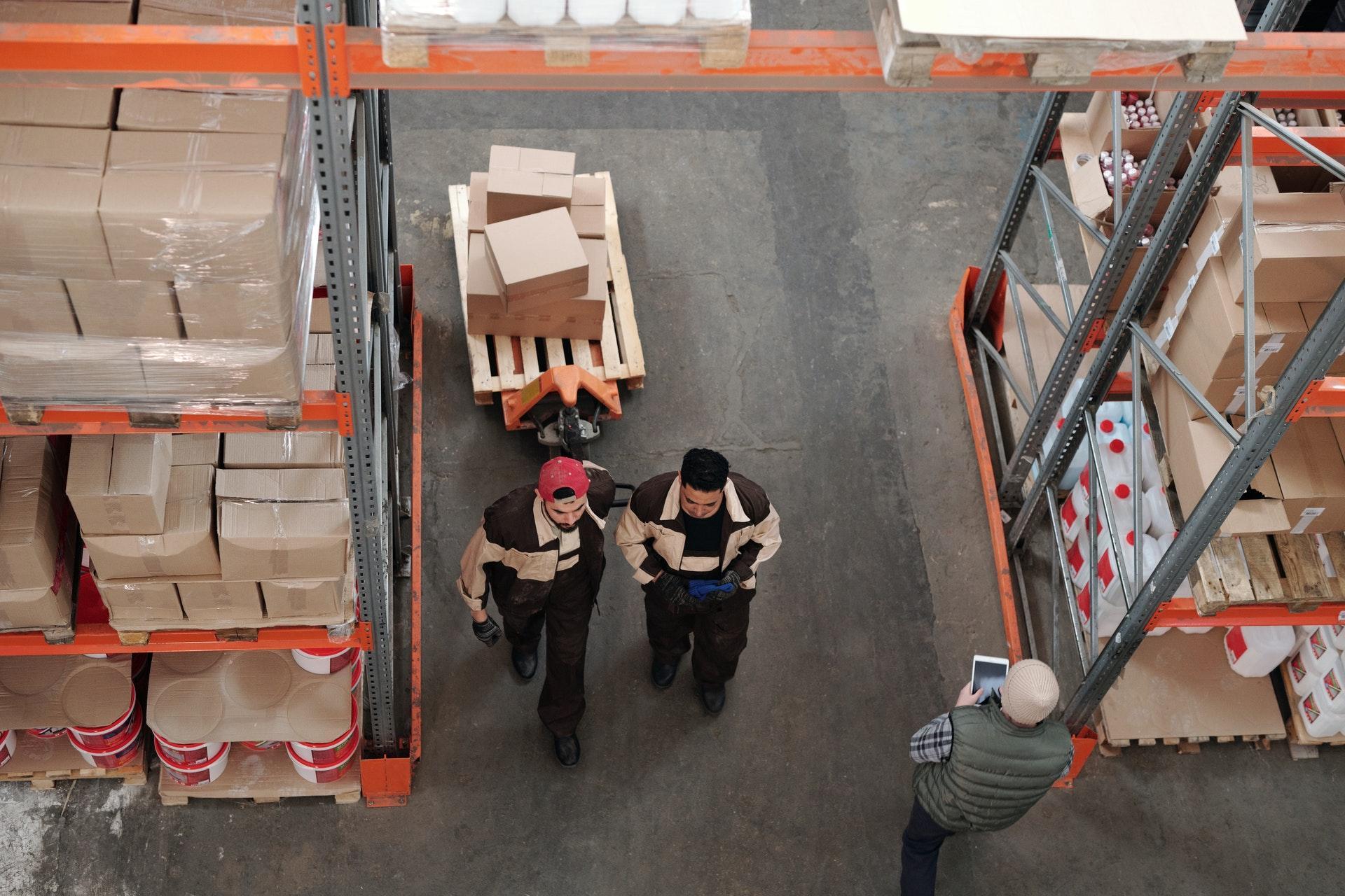 Two men in a warehouse fulfilling dropshipping orders for an ecommerce store.