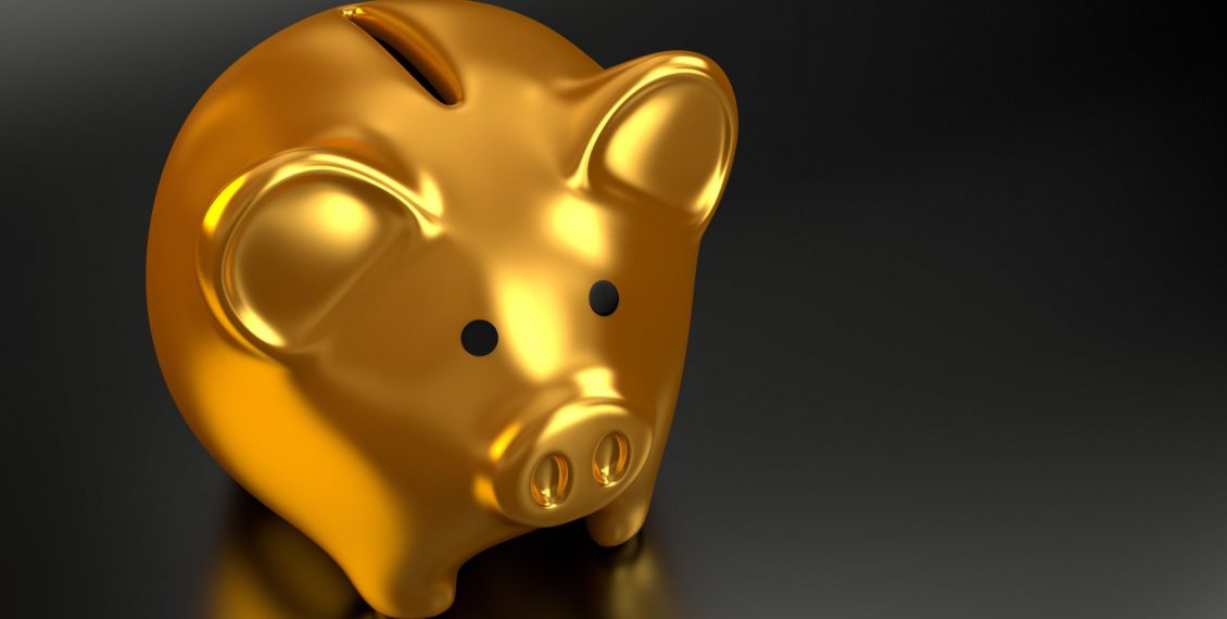 A gold piggy bank set on a black reflective surface could be the reward for your business if you follow our coronavirus ecommerce tips
