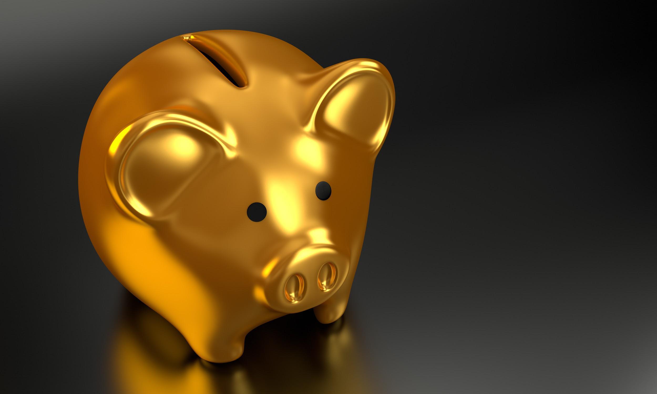 A gold piggy bank set on a black reflective surface could be the reward for your business if you follow our coronavirus ecommerce tips