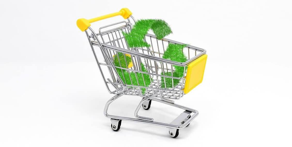 A shopping cart containing the recycling symbol.