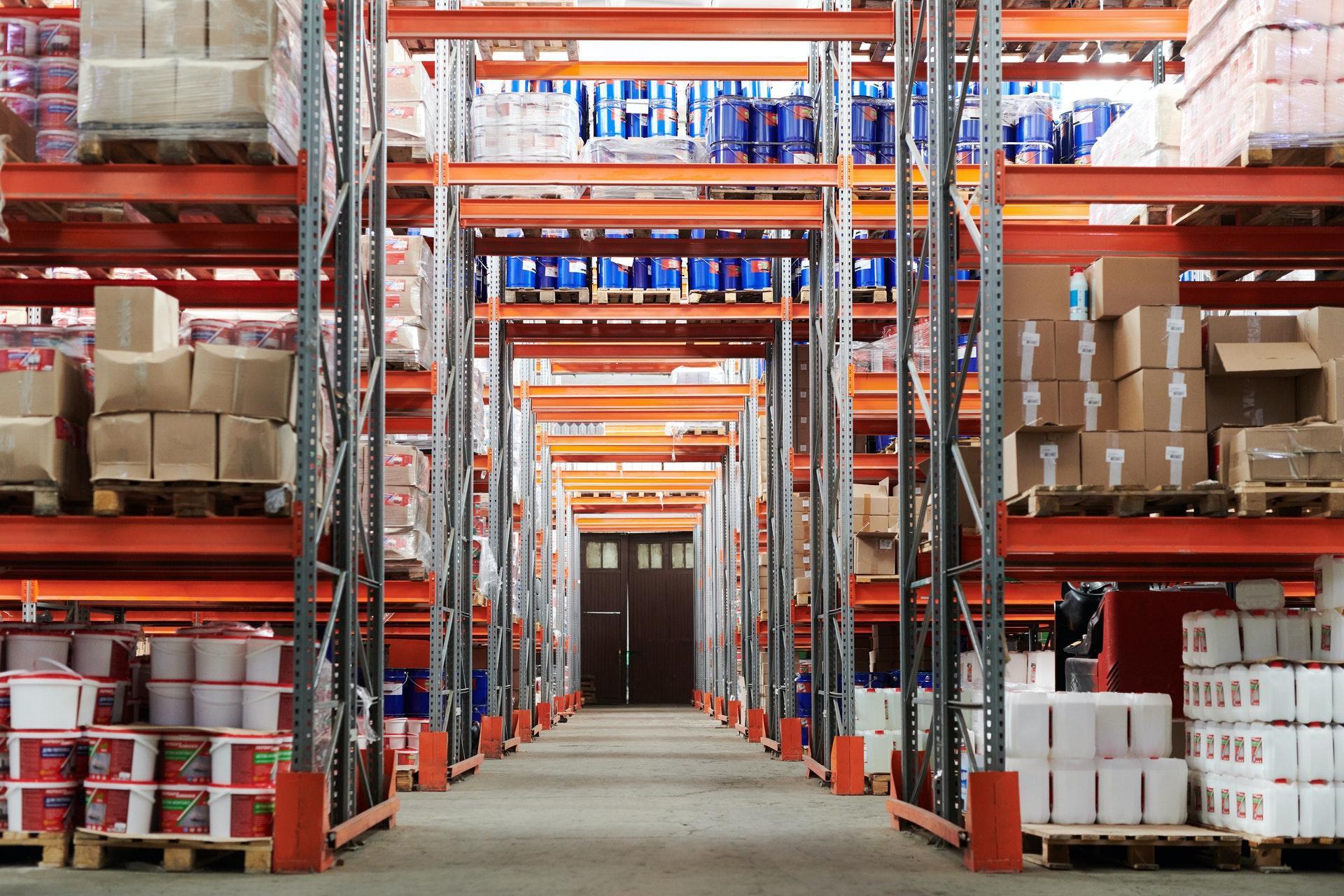 A big warehouse with shelves stacked with boxes of products.
