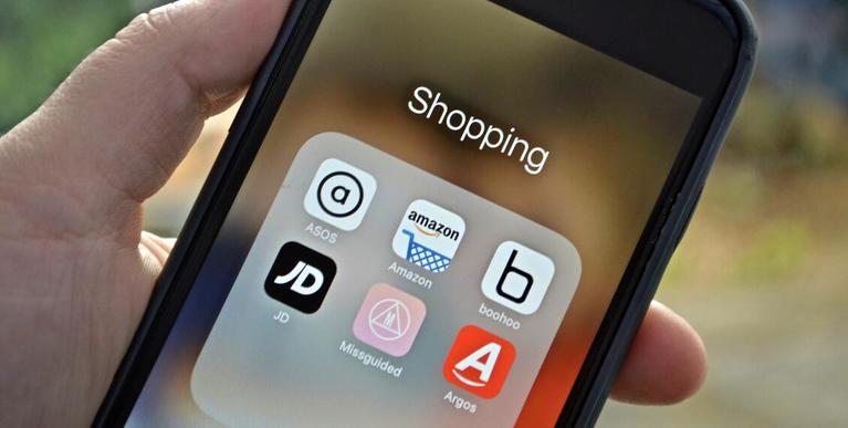 A phone screen showing an open group of shopping apps.