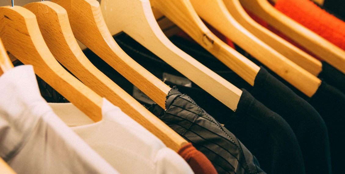 Row of t-shirts on hangers on a clothing rail for a print on demand company.