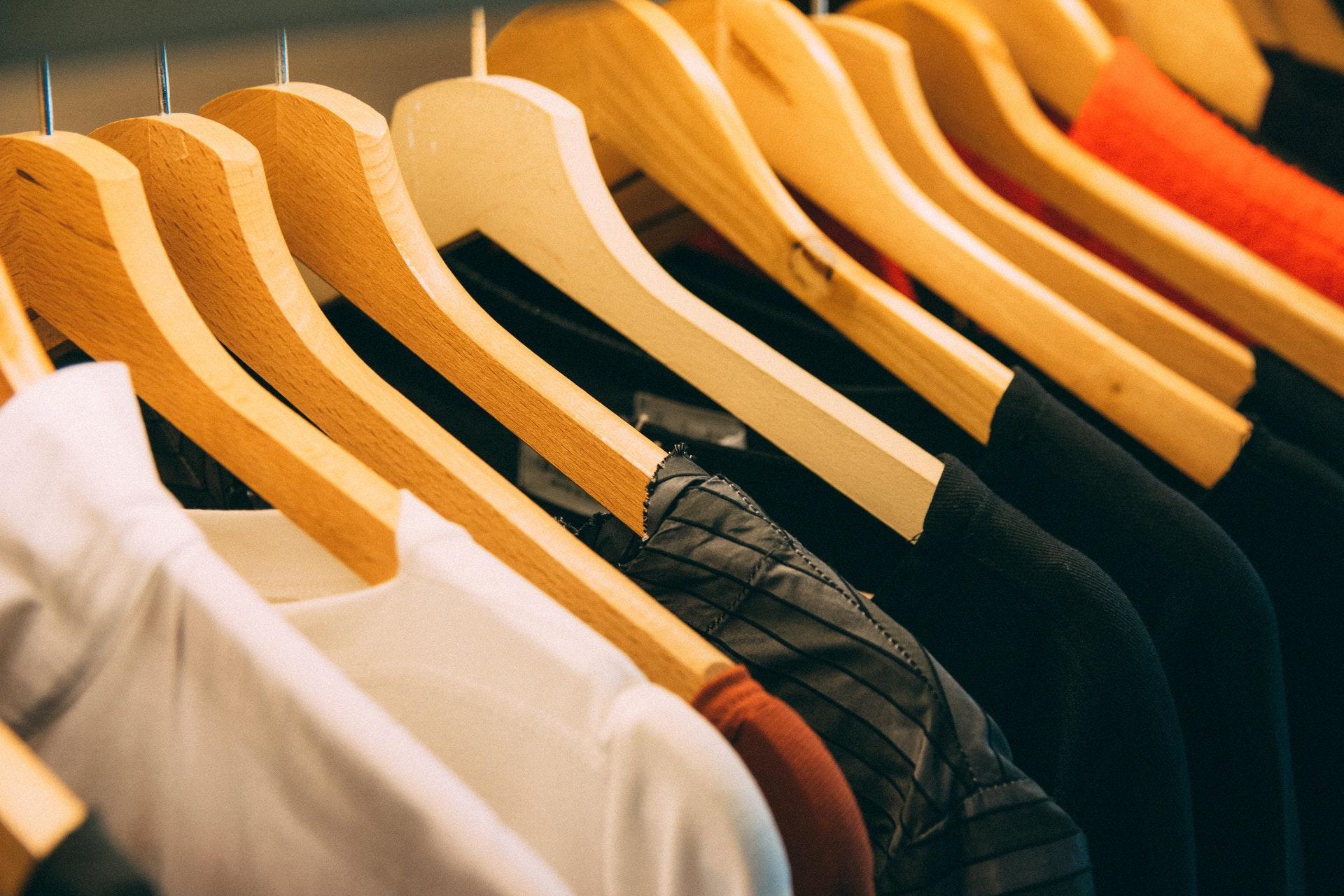 Row of t-shirts on hangers on a clothing rail for a print on demand company.